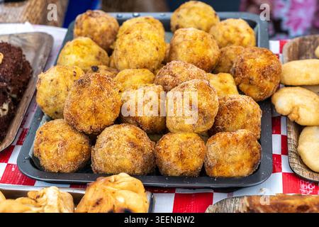 Cheese potatoes fried balls, crispy croquettes stuffed with mozzarella, sphere fritters, tasty snack balls, street food closeup Stock Photo