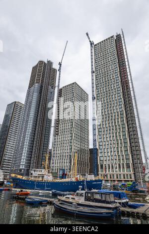 High-rise buildings under construction at an urban waterfront harbor. London, UK, 9 June 2024 Stock Photo
