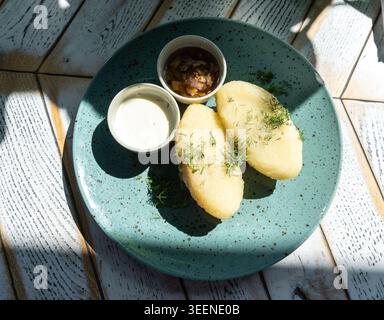 Lithuanian potato dumplings, cepelinai pancakes or kolduny, meat stuffed draniki, traditional lithuanian didzkukuliai or deruny. Kalduny potato latkes Stock Photo