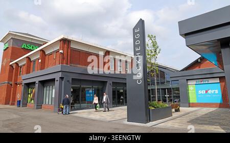 New Cockhedge logo and entrance signage in Warrington, with Asda and Savers visible during the shopping park remodelling Stock Photo