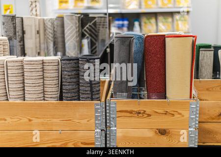 Rolled carpet runners and flooring samples displayed in home improvement store Stock Photo