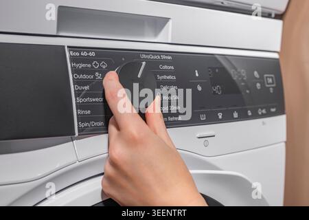 Setting and choosing laundry program on washing machine panel Stock Photo
