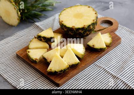 Organic Pineapple Wedges Freshly Sliced on a Cutting Board, side view. Stock Photo