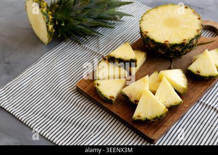 Organic Pineapple Wedges Freshly Sliced on a Cutting Board, side view. Stock Photo