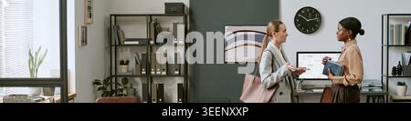 Businesswomen Discussing Project Planning in Modern Office Stock Photo