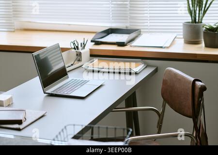 Modern Office Workspace Featuring Laptop for Remote Work Setup Stock Photo