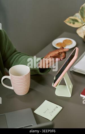 Black Woman Using Tablet for Remote Work and Digital Planning Stock Photo