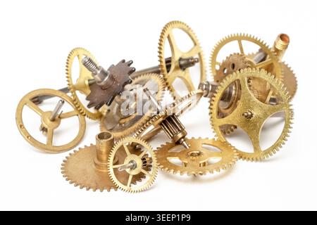 Close-up of a pile of antique metallic cogwheels and clock components Stock Photo