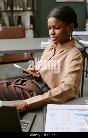 Black Adult Woman Using Smartphone for Business Communication Stock Photo
