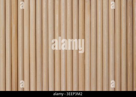 Full frame texture background of parallel wooden dowel rods arranged vertically Stock Photo