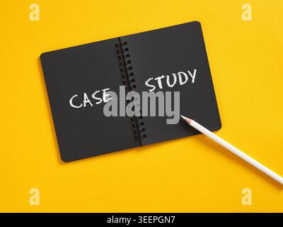 Black spiral notebook displaying CASE STUDY text on yellow background, representing business analysis and research Stock Photo