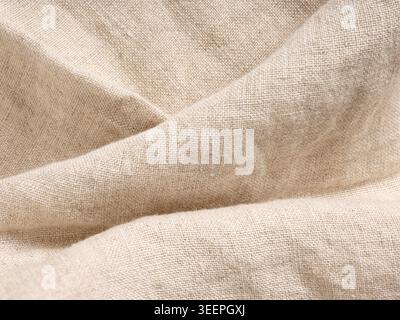 Natural beige linen fabric with woven texture and subtle folds, perfect for textile and organic material concepts Stock Photo
