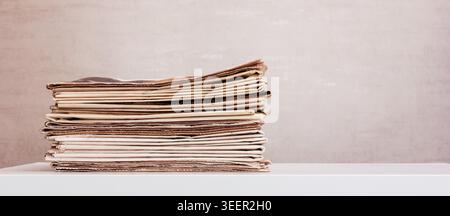 a large stack of newspapers on the table with copy space Stock Photo