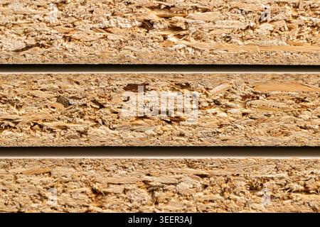 Pressed wood in sheets, the edge of pressed wood with a high particle density and an organic surface with natural shades of beige. Stock Photo