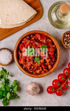 Chili Con Carne in bowl on dark background. Mexican cuisine. Top view Stock Photo