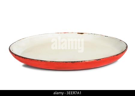 Old scratched red enameled plate isolated on white background Stock Photo