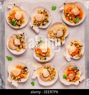 Cooked scallops with sauce on a baking sheet Stock Photo