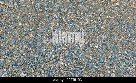Overhead shot featuring countless small pebbles. Soft neutral lighting highlight various stone textures, ideal for backgrounds needing nuanced, earthy Stock Photo