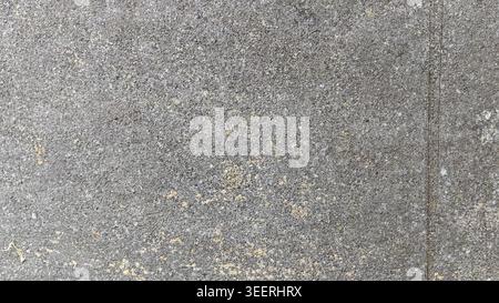 Shot of grey concrete surface. Features visible texture and subtle tonal variations. Lighting highlights the granular detail. Well suited to backgroun Stock Photo