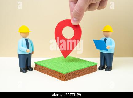 Engineers inspect a plot of land before construction. Land allocation for development. Site analysis, urban planning and infrastructure preparation fo Stock Photo