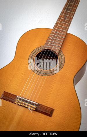 Close up of classical Spanish guitar with wooden body and strings Stock Photo