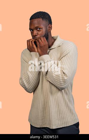 Young man biting his nails showing anxiety and nervousness Stock Photo