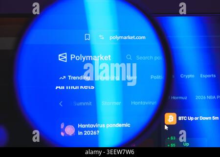 Polymarket website interface viewed through magnifying glass, decentralized prediction market platform for betting on politics, crypto, and global Stock Photo