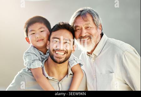 Grandpa, boy and father with piggyback for portrait, weekend support and connection for relationship. Bonding, outdoor together and Asian people with Stock Photo