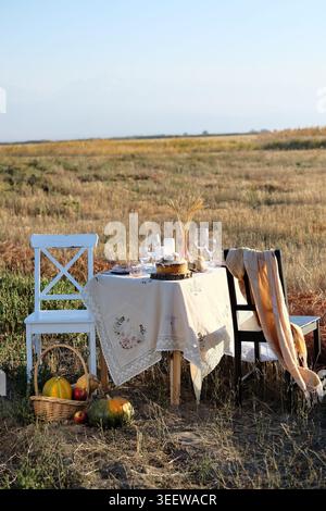 Autumn harvest setting. Fall themed table with pumpkins and linens Stock Photo