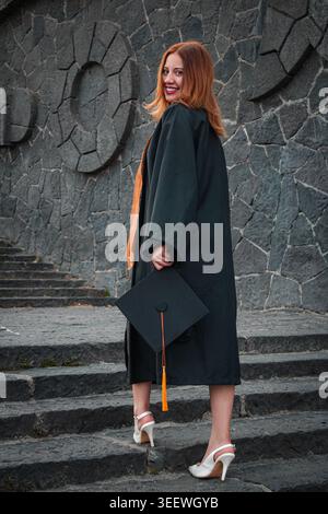 Student goes upstairs and smiles at the camera Stock Photo