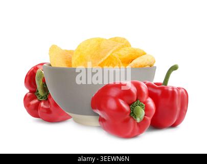 Chips with paprika flavor. Potato crisps in bowl and fresh bell peppers isolated on white Stock Photo