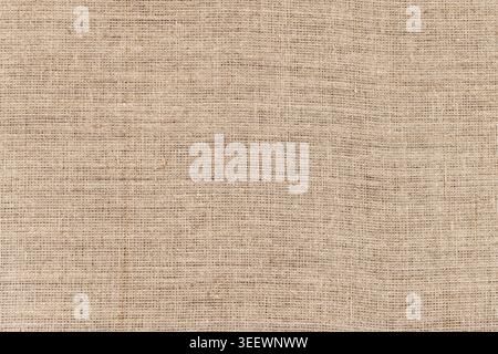 Rough woven burlap fabric in neutral beige tones, perfect as a rustic background, packaging material, craft surface, or textile texture for product ph Stock Photo