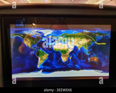 An in-flight entertainment screen displaying a digital flight map showing the route between Copenhagen Airport (CPH) and Tokyo Haneda Airport (HND). Stock Photo