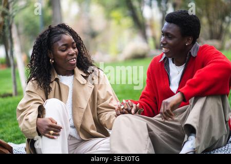 Positive loving couple african american man and woman enjoying time together in nature in city park. Stock Photo