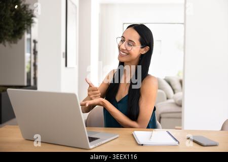 Woman communicating with sign language during video call Stock Photo