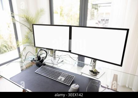 Modern home office with dual white mock up monitors Stock Photo