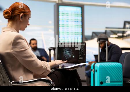 Corporate woman working with AI assistant software on laptop in business lounge, exploring machine learning autonomous systems. Global business travel with generative models. Stock Photo