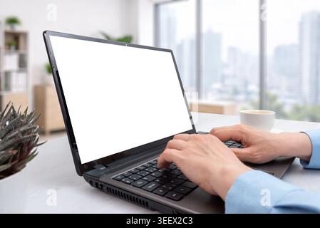 Modern laptop mockup in bright office with city background, suitable for software presentation, online business, education or technology advertising p Stock Photo
