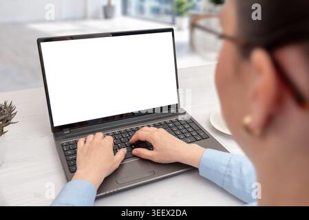 Female professional working on laptop with isolated display in contemporary office, designed for branding, SaaS, online learning or marketing mockup u Stock Photo