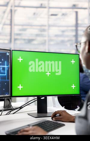 Isolated screen PC and AI deep learning in PCB factory office used by engineer to optimize hardware. Specialist uses artificial intelligence and chroma key computer to improve manufacturing, close up Stock Photo