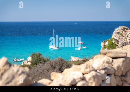 Cala Rossa, Favignana, Italy. Sailboats and boats on turquoise water Stock Photo