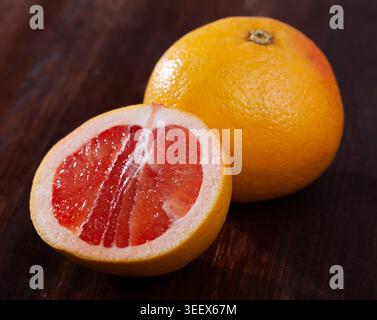 Sliced grapefruit on wooden table Stock Photo