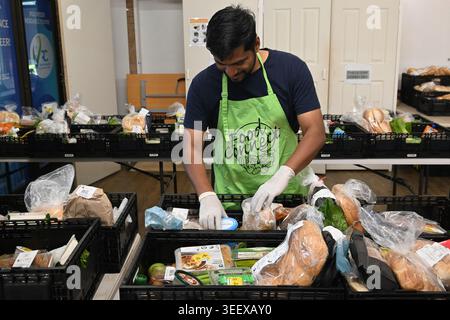 PORT MACQUARIE, NSW - APR 12 2026:A young adult Australian man helps organize donated food supplies for community support programs in Australia.Food r Stock Photo