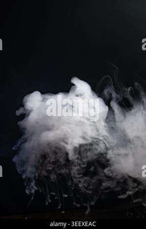 Dense white smoke cloud isolated on black background Stock Photo