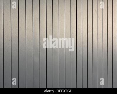 Abstract texture background metal wall showing vertical line pattern silver gray corrugated surface conveying calm neutral feeling building exterior m Stock Photo