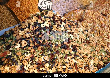 Stall sells mixed nuts and dried fruits in busy spot Stock Photo