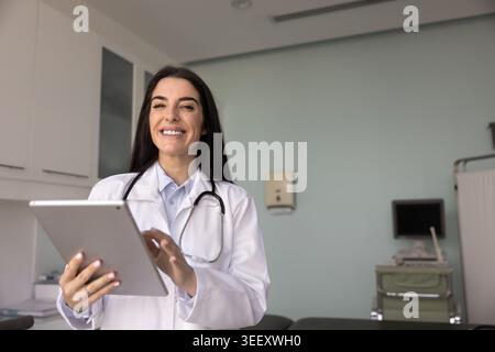 Latina healthcare professional woman posing for camera with tablet Stock Photo