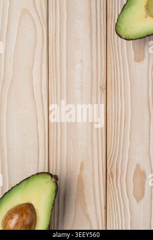 Avocado background with copy space on light wooden texture Stock Photo