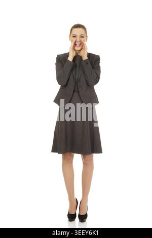 Young smiling business woman screaming loud or calling someone Stock Photo