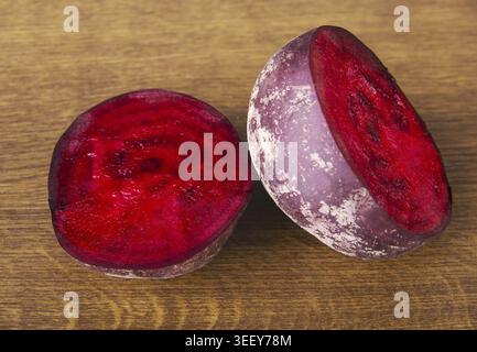 One beetroot divided into two. Over wooden background Stock Photo